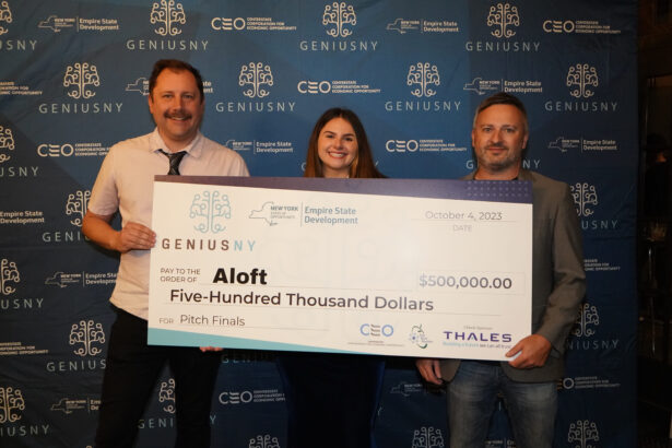 Aloft Team Posing with Large Check